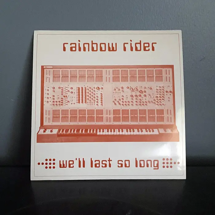 A photo of Rainbow Rider's We'll Last So Long against a dark backdrop