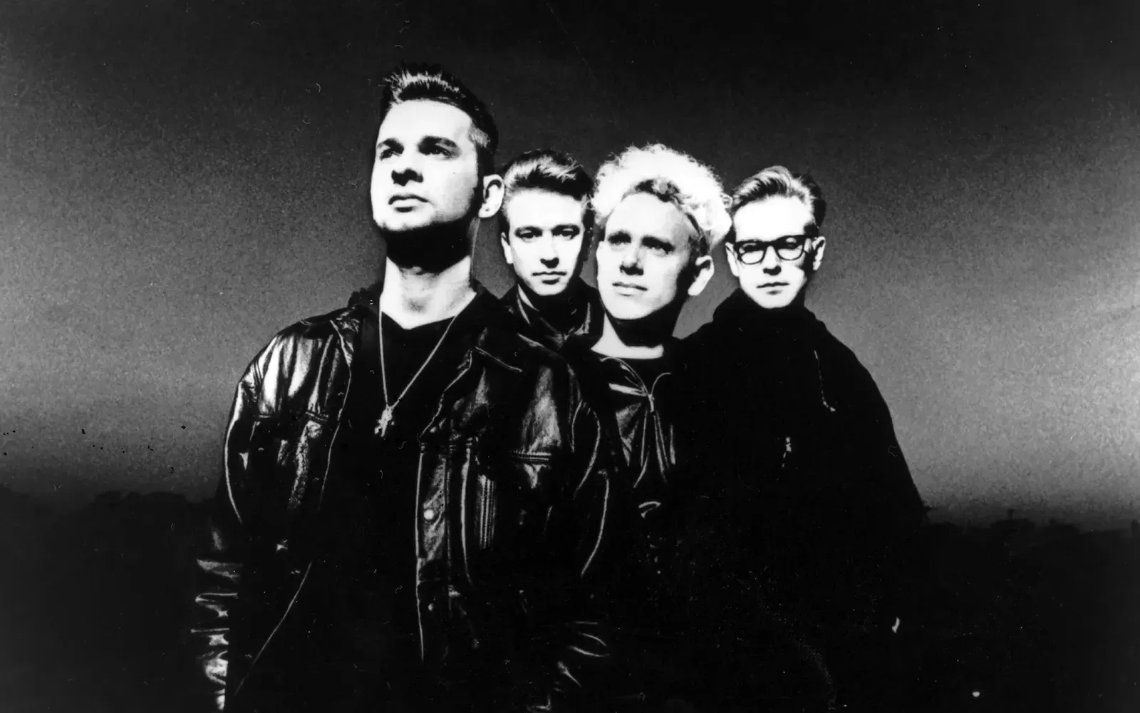 A black-and-white photo of the four members of Depeche Mode from the early 1990s
