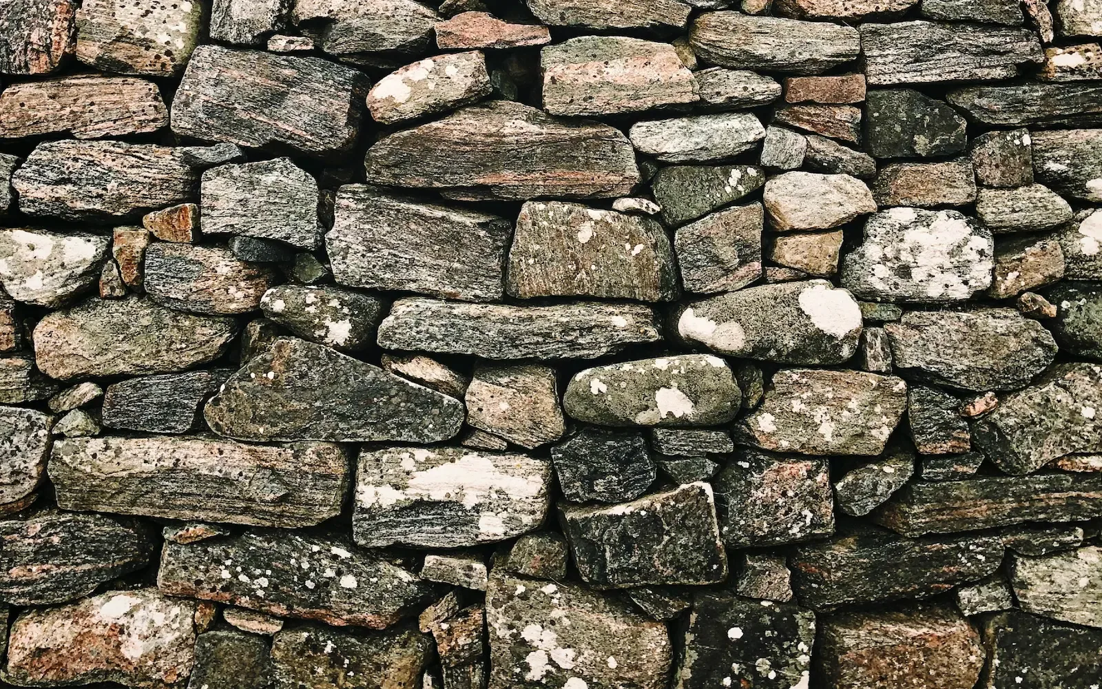 A photograph of an intricately arranged stone wall