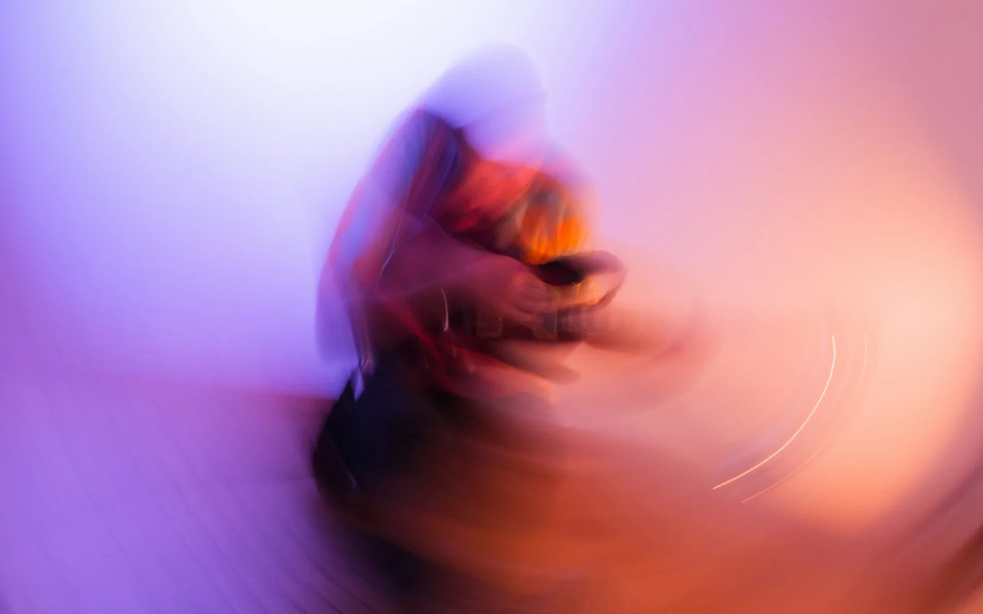 A blurry image of someone playing a guitar